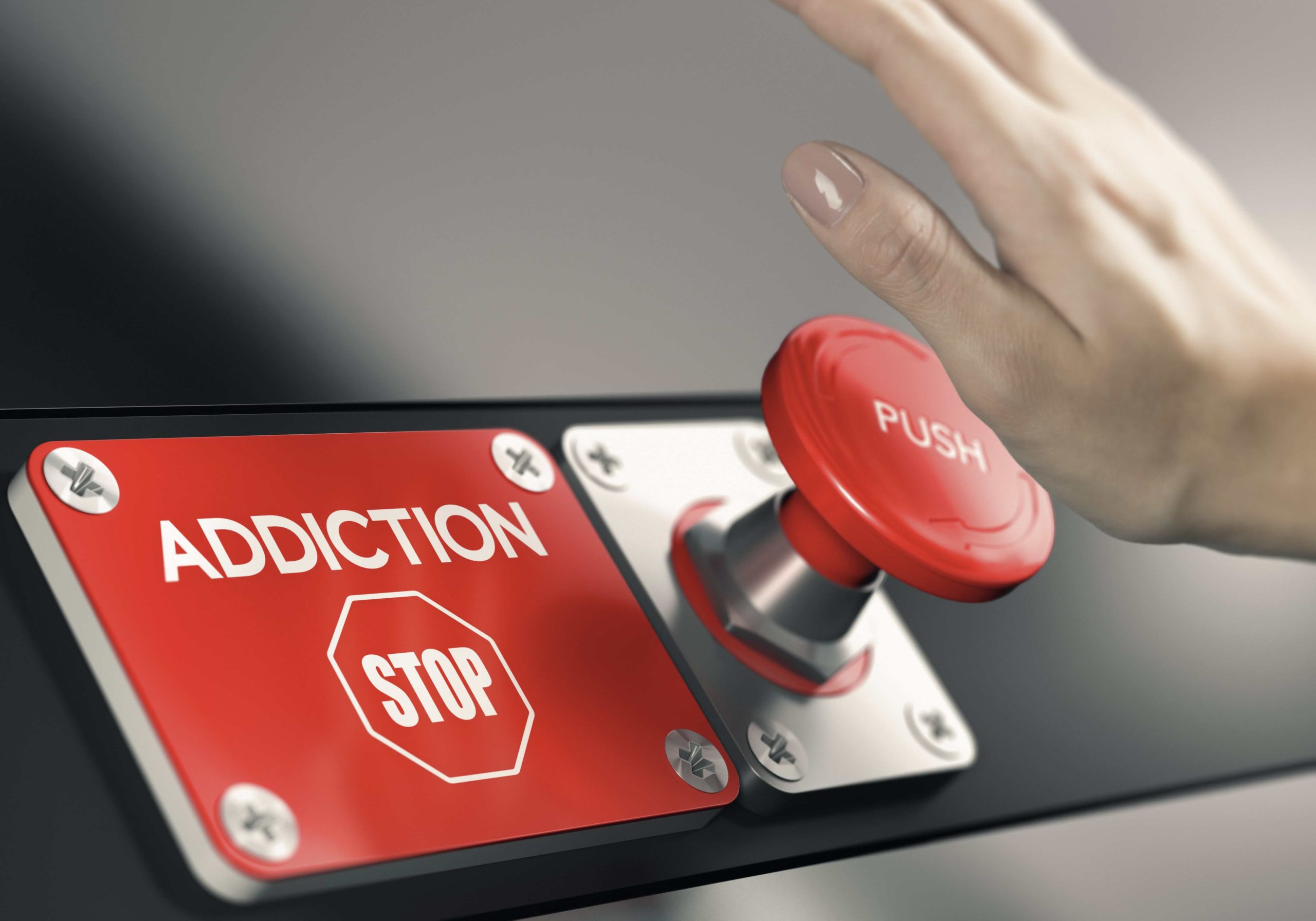 hand pressing a stop addiction button