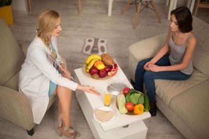 woman in recovery discussing nutrition with a doctor